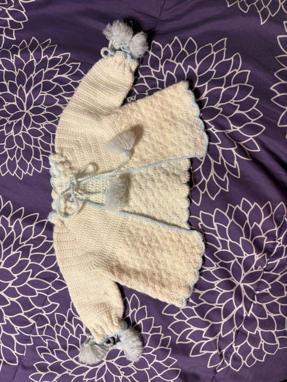 Hand knitted baby jacket, sparkly white with blue accents